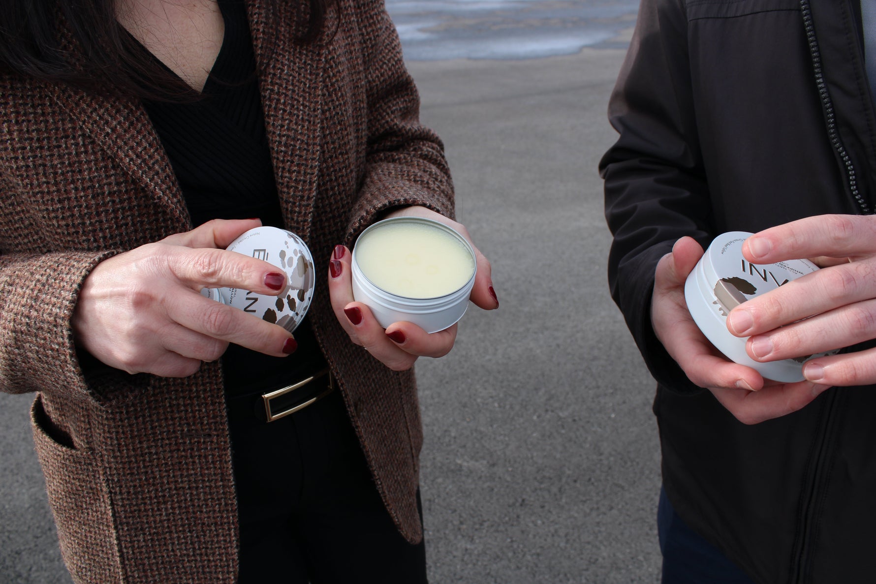 woman and man holding grass-fed beef tallow creams casually