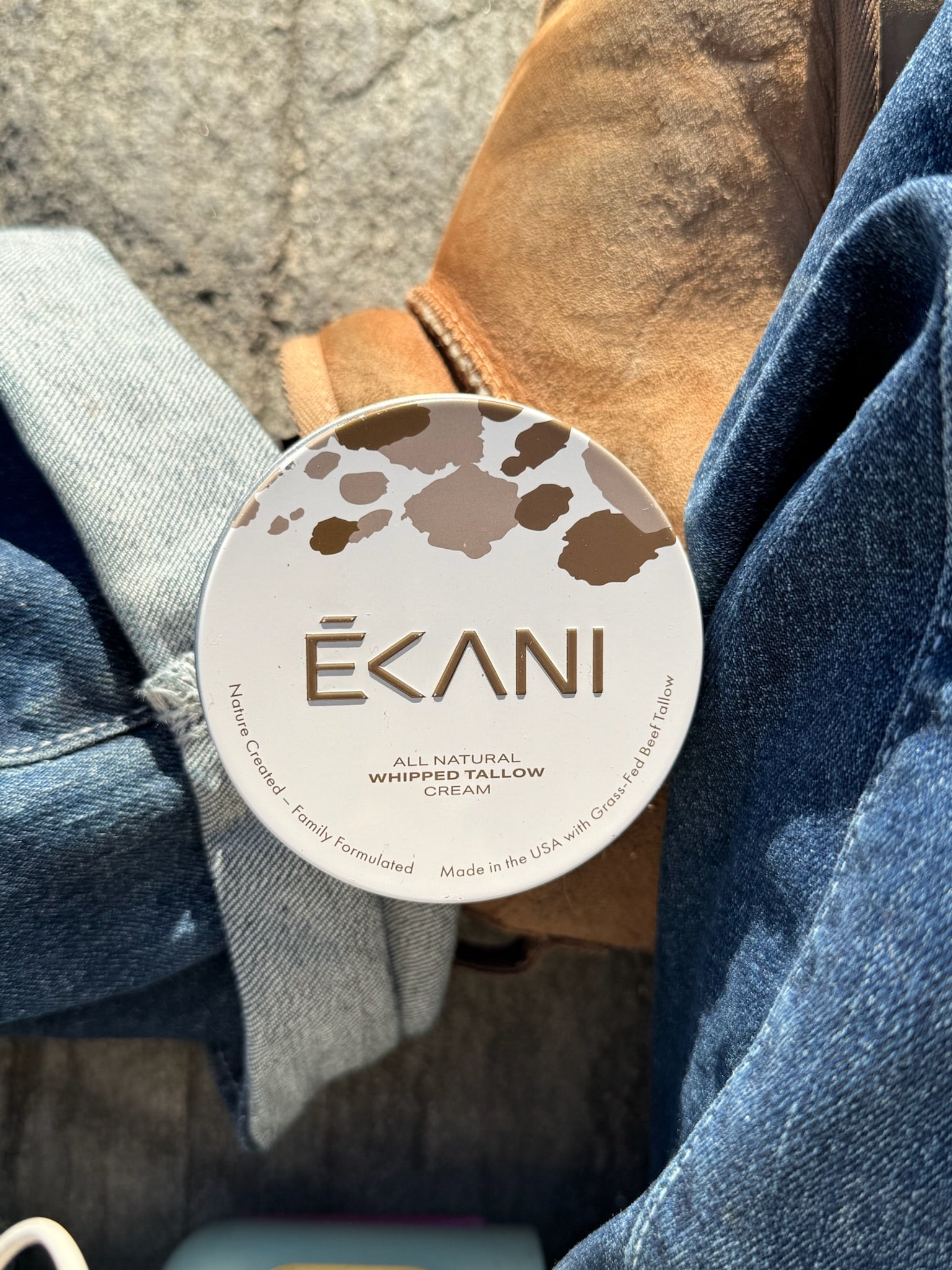organic grass-fed tallow cream with Ecani logo sitting on ankles