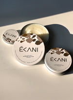 Écani all-natural grasss-fed tallow cream containers on a light surface with a neutral background